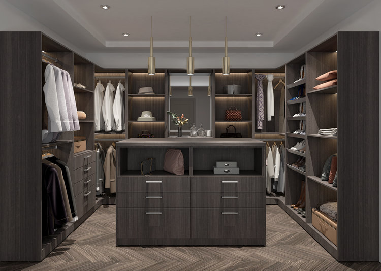 Luxurious walk-in closet with a central island, hanging clothes, shelves, and accessories on display.